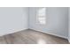 Bedroom features wood-look floors, baseboards, window and light blue paint at 2320 W Walnut St, Tampa, FL 33607