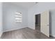 Bedroom with window, wood-look floors, white baseboards and light blue paint at 2320 W Walnut St, Tampa, FL 33607
