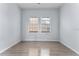 Bedroom with wood-look floors, white paint and window bringing in natural light at 2320 W Walnut St, Tampa, FL 33607