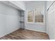 Bedroom closet with shelving, window, wood-look floors and light blue paint at 2320 W Walnut St, Tampa, FL 33607