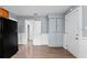 Spacious kitchen featuring sleek black refrigerator, hardwood floors, pantry and light blue paint at 2320 W Walnut St, Tampa, FL 33607