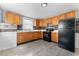 Modern kitchen featuring wooden cabinets, stainless steel appliances, and stylish backsplash at 2320 W Walnut St, Tampa, FL 33607