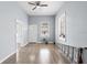 Spacious living room featuring wood-look floors, a ceiling fan, and ample natural light at 2320 W Walnut St, Tampa, FL 33607