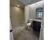 Renovated bathroom featuring a walk-in shower, wood-look tile floors, and a granite vanity at 2332 S Fairway Dr, Plant City, FL 33566