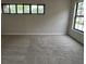 Bedroom featuring neutral walls, carpet flooring, and black framed windows at 2332 S Fairway Dr, Plant City, FL 33566