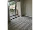 Bedroom with sliding glass door, neutral walls, and carpet flooring to a balcony at 2332 S Fairway Dr, Plant City, FL 33566