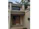 Home's entrance features a charming red door, textured facade, and covered entry at 2332 S Fairway Dr, Plant City, FL 33566