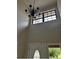 This entryway features a decorative light fixture, a window, and a white front door at 2332 S Fairway Dr, Plant City, FL 33566