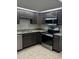 Updated kitchen with stainless steel appliances, granite countertops, and dark wood cabinets at 2332 S Fairway Dr, Plant City, FL 33566