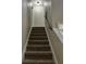 Carpeted staircase with a white railing leads to the upper level of the home at 2332 S Fairway Dr, Plant City, FL 33566