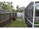Backyard view featuring both a wooden and vinyl fence, plus a screened in pool at 2470 Del Rio Way, Dunedin, FL 34698