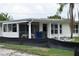 Quaint single-story home features a screened in porch and bright natural light at 2470 Del Rio Way, Dunedin, FL 34698