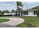 Charming single-story home with a cozy carport and beautiful mature palm tree at 2470 Del Rio Way, Dunedin, FL 34698