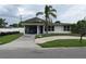 Charming single-story home with a cozy carport and beautiful mature palm tree at 2470 Del Rio Way, Dunedin, FL 34698