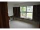 Unfinished living room with exposed walls and large window overlooking the front yard at 2470 Del Rio Way, Dunedin, FL 34698