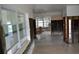 Bright open living space ready for renovation, featuring large windows and tile flooring at 2470 Del Rio Way, Dunedin, FL 34698