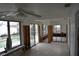 Spacious living room area with pool views and ceiling fan at 2470 Del Rio Way, Dunedin, FL 34698