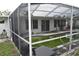 Screened-in pool area awaiting refreshing clear water and relaxation at 2470 Del Rio Way, Dunedin, FL 34698