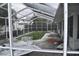 Screened-in pool area featuring an in-ground pool, patio space, and overhead protection at 2470 Del Rio Way, Dunedin, FL 34698