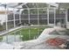View of in-ground pool inside screened enclosure and patio space, ideal for leisure and outdoor activities at 2470 Del Rio Way, Dunedin, FL 34698