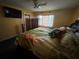 Bedroom with a queen-sized bed, tropical bedding and plenty of natural light at 2701 W Cherry St, Tampa, FL 33607