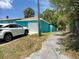 Bright blue house with white trim and a white car in the driveway at 2701 W Cherry St, Tampa, FL 33607