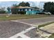 Charming turquoise and white home with brick street and lush lawn at 2701 W Cherry St, Tampa, FL 33607
