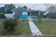 Well-maintained front yard leads to a cozy home with a screened porch at 2701 W Cherry St, Tampa, FL 33607