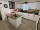 Bright kitchen with white cabinets, stainless steel appliances and a center island with granite countertop at 2701 W Cherry St, Tampa, FL 33607