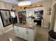 Bright kitchen featuring white cabinets, stainless steel appliances and a center island with granite countertop at 2701 W Cherry St, Tampa, FL 33607