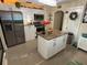 Bright kitchen with white cabinets, stainless steel appliances and a center island with granite countertop at 2701 W Cherry St, Tampa, FL 33607