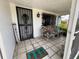 Inviting front porch with seating, decorative accents, and secure door at 2701 W Cherry St, Tampa, FL 33607