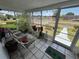 Relaxing screened-in porch with seating, plants, and street view at 2701 W Cherry St, Tampa, FL 33607