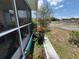 View of street and landscaped yard from cozy, screened-in porch at 2701 W Cherry St, Tampa, FL 33607