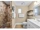Cozy bathroom features a tiled walk-in shower and a white vanity for a blend of rustic charm and modern convenience at 2709 Upton S St, Gulfport, FL 33711