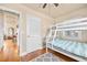 A bedroom with a bunk bed, hardwood floors, and easy access to other parts of the house at 2709 Upton S St, Gulfport, FL 33711