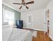 Bedroom with hardwood floors, blue accent wall, ceiling fan, and a mirrored closet for a stylish and comfortable space at 2709 Upton S St, Gulfport, FL 33711