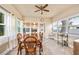Bright dining room features wood-look floors, ceiling fan, and multiple windows at 2709 Upton S St, Gulfport, FL 33711