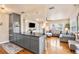 Open concept kitchen with gray cabinets, hardwood floors, and stainless steel appliances at 2709 Upton S St, Gulfport, FL 33711