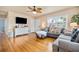 Comfortable living room featuring hardwood floors, a ceiling fan, and a view of the front yard at 2709 Upton S St, Gulfport, FL 33711