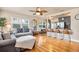 Open-concept living space with hardwood floors seamlessly flows into the kitchen with a breakfast bar at 2709 Upton S St, Gulfport, FL 33711