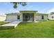 Expansive backyard features a covered patio, perfect for outdoor entertaining and relaxing at 2718 Chipley Ave, North Port, FL 34286