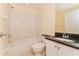 A practical bathroom features a tiled shower-tub combination and vanity at 2718 Chipley Ave, North Port, FL 34286