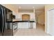 Modern kitchen with stainless appliances, white cabinetry, and an open layout at 2718 Chipley Ave, North Port, FL 34286