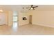 A bright living room features tile floors and an open floor plan leading to the kitchen at 2718 Chipley Ave, North Port, FL 34286