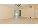 Open living room featuring tile flooring, neutral paint, and sliding doors to screened porch at 2718 Chipley Ave, North Port, FL 34286