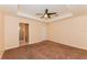 Spacious main bedroom with carpet flooring, ceiling fan, and ensuite bathroom at 2718 Chipley Ave, North Port, FL 34286