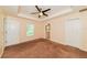 Serene main bedroom with carpet flooring, ceiling fan, and bright ensuite bathroom at 2718 Chipley Ave, North Port, FL 34286