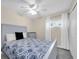 Comfortable bedroom featuring a ceiling fan, plush bedding, and natural light from a window at 2943 Bough Ave # C, Clearwater, FL 33760