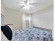 Bedroom featuring blue and white bedding, neutral walls, carpet, and ample closet space at 2943 Bough Ave # C, Clearwater, FL 33760